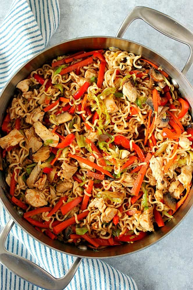 Overhead shot of chicken yakisoba in a saucepan with two handles.