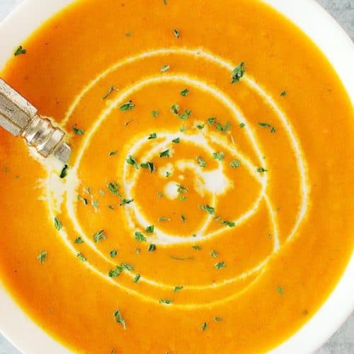 Creamy Carrot Soup in white bowl.