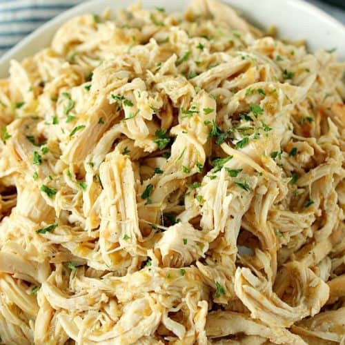 Instant Pot Salsa Verde Chicken shredded in a bowl.