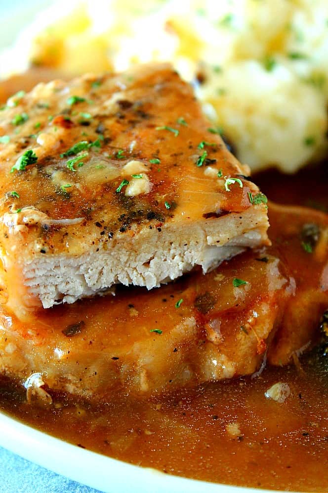 Instant Pot Pork Chops with gravy on a plate.