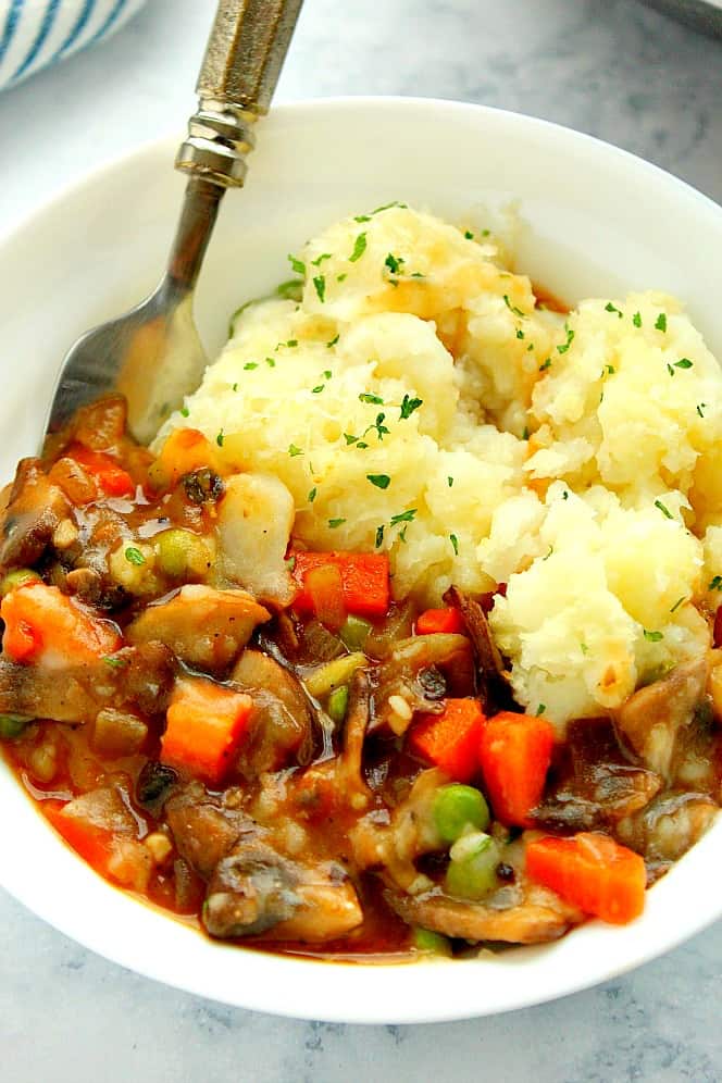 Side shot of vegetarian Shepherd's Pie in white bowl. 