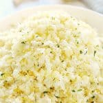 Cauliflower rice with lemon in a bowl.