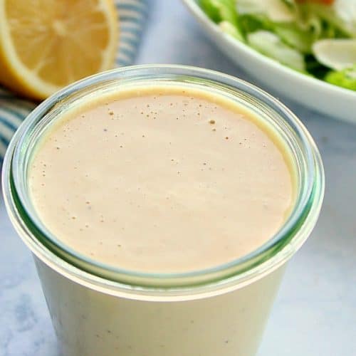 Salad dressing in a medium glass jar.