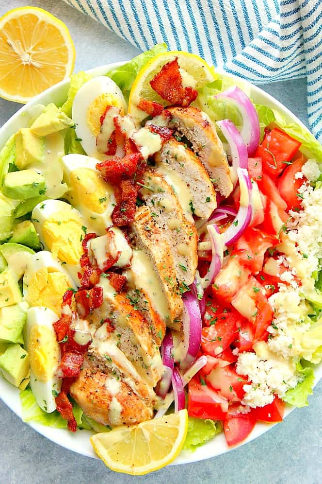 Overhead shot of chicken Cobb salad in white salad bowl.