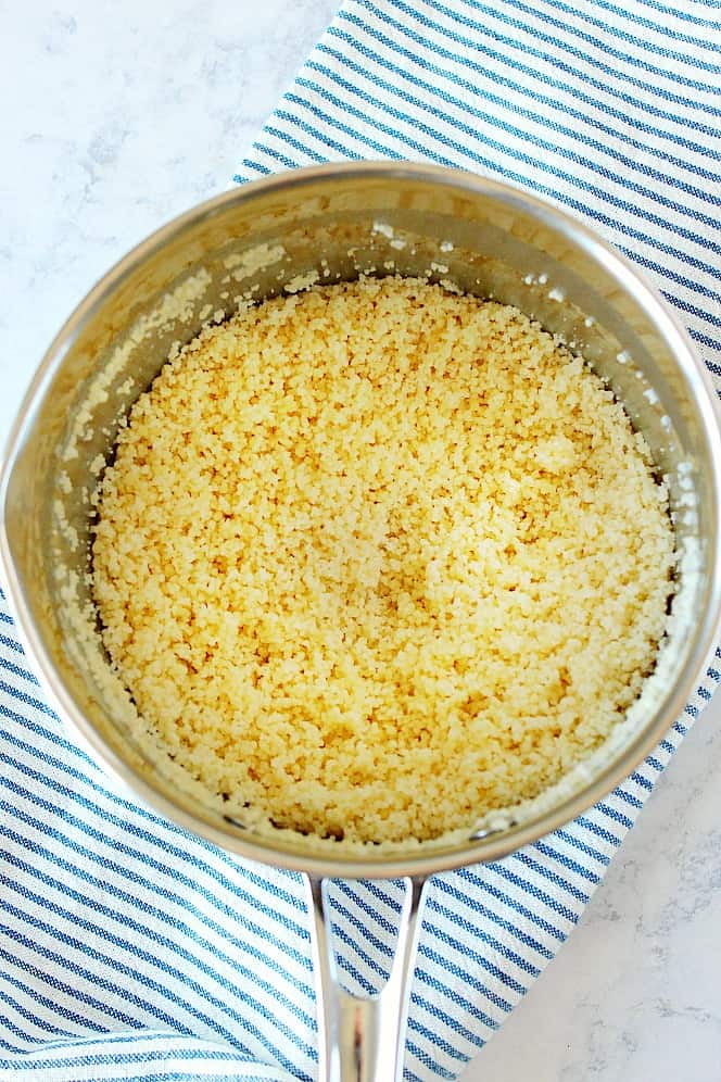 Overhead shot of cooked couscous in pot.