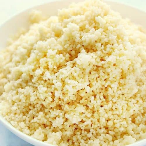 Cooked couscous in a white bowl.