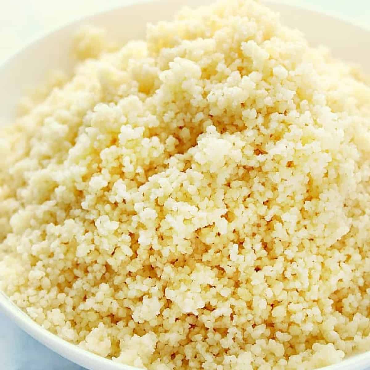 Cooked couscous in a white bowl.