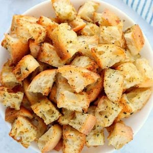 Homemade croutons in a white bowl.