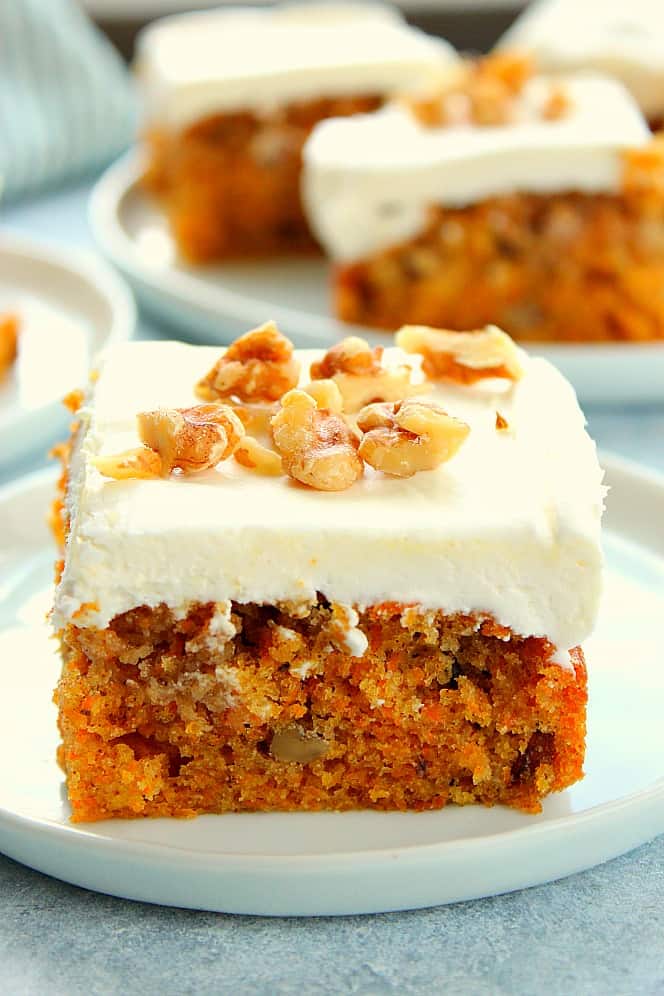 Moist Carrot Cake piece on white plate.