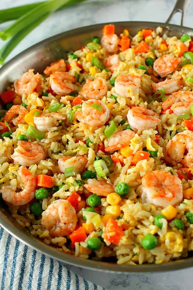 Side close up shot of shrimp fried rice in stainless steel pan.