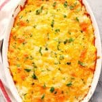 Hashbrown casserole in white oval dish.