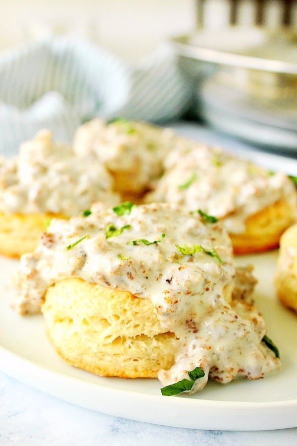 Biscuits on plate with gravy on top.