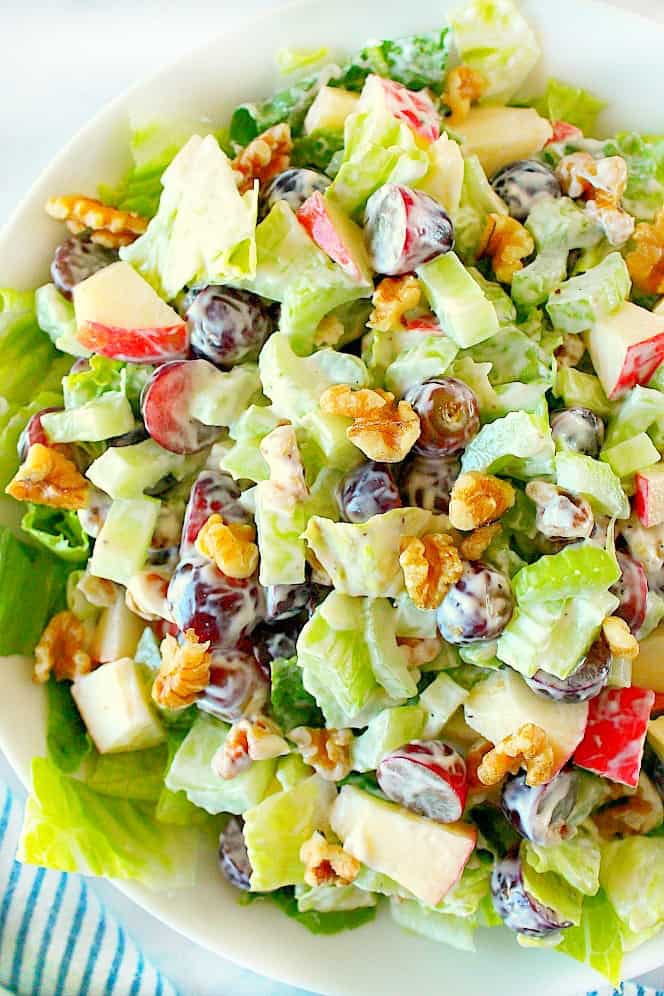 Overhead shot of creamy Waldorf salad, in white bowl.