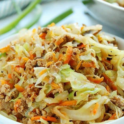 Side shot of egg roll filling in a bowl.