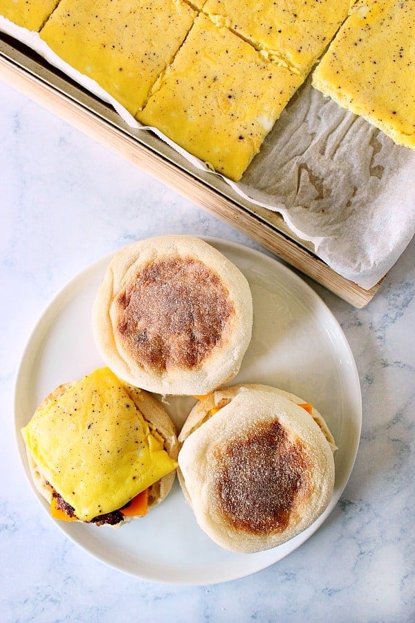 Freezer Breakfast Sandwiches being assembled on white plate.