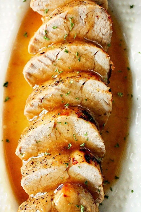 Overhead shot of sliced pork tenderloin with gravy.