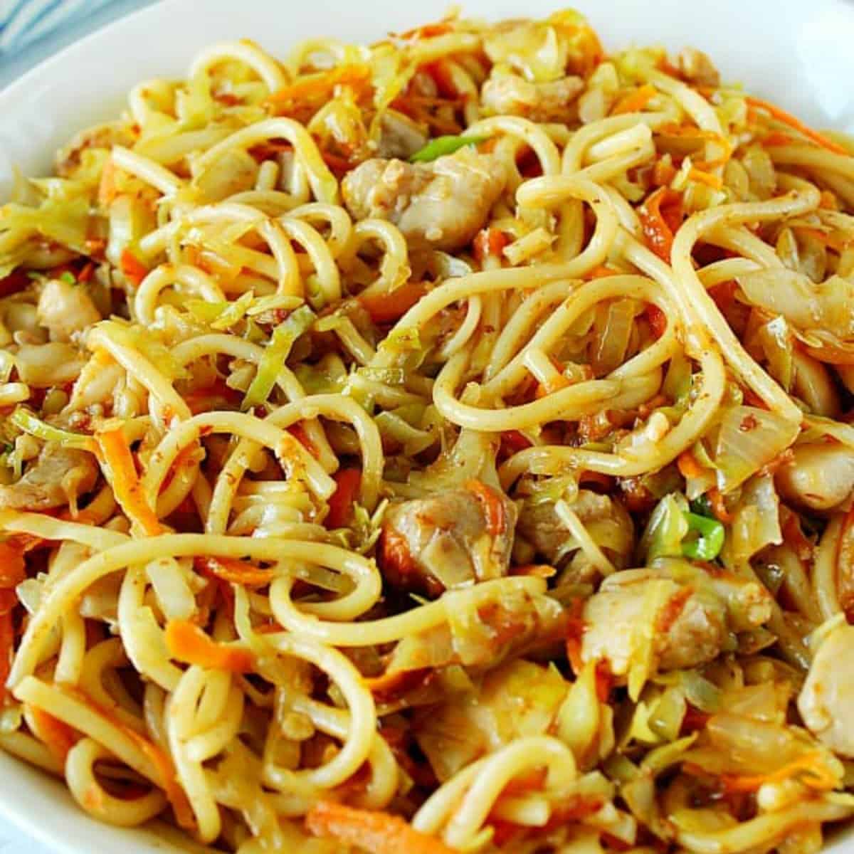 Chicken chow mein in a white bowl.