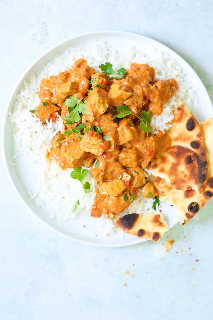 Instant Pot Butter Chicken with rice and flatbread on plate.