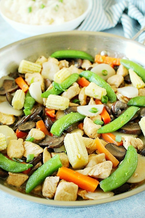 This delicious Moo Goo Gai Pan is a quick and easy chicken and mushroom stir fry for your busy weeknights! This vegetable-packed and saucy dish is perfect with rice. Moo Goo Gai Pan in stainless steel pan.