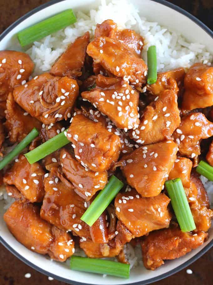 Instant Pot Mongolian Chicken over white rice in a bowl.