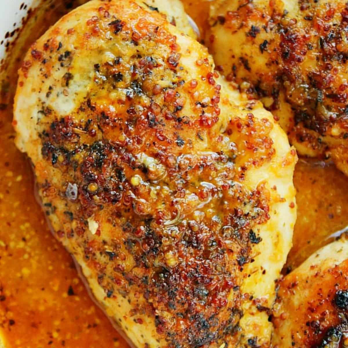 Honey mustard chicken in a baking dish.