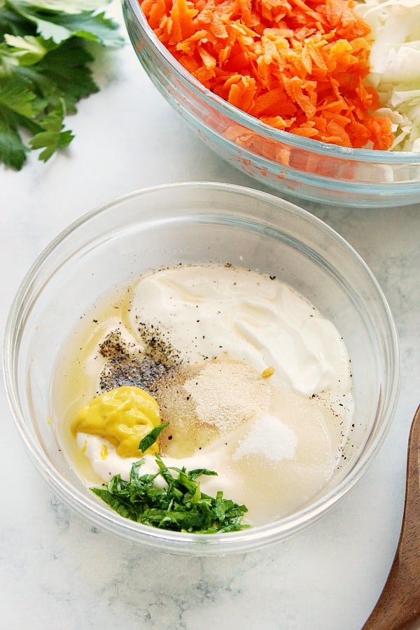 Ingredients for creamy coleslaw dressing in glass bowl.