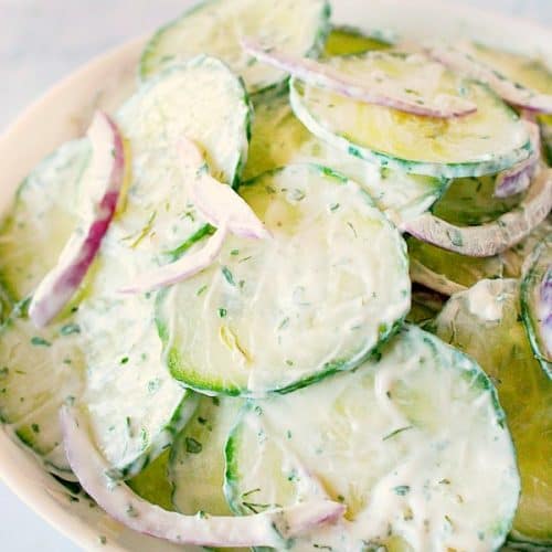 Creamy Cucumber Salad in a white salad bowl.