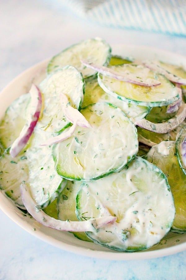 Creamy Cucumber Salad in a white salad bowl.