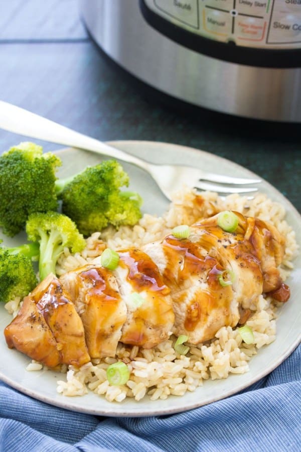 Instant Pot Honey Garlic Chicken on top of rice with broccoli on side.