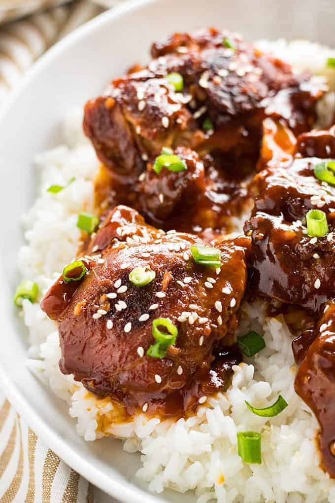 Instant Pot Honey Sesame Chicken Thighs on white rice in bowl.