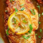 Close up on Chicken Francese in sauce in pan.