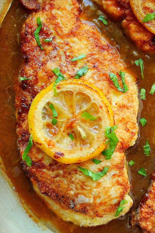 Close up on Chicken Francese in sauce in pan.