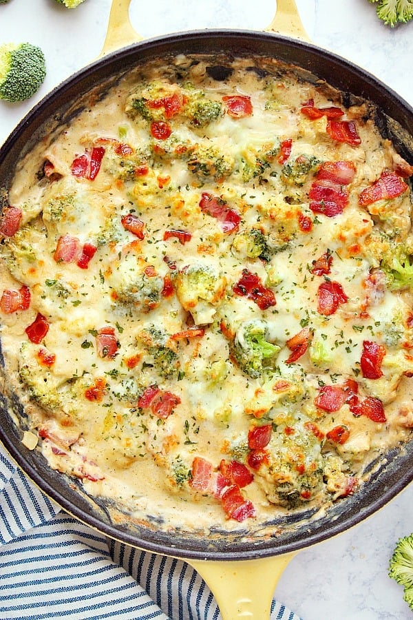 Creamy Broccoli with Bacon - your new favorite side dish! Steamed broccoli in creamy Parmesan sauce and bacon comes together in just 30 minutes. Creamy Broccoli in cast iron skillet.