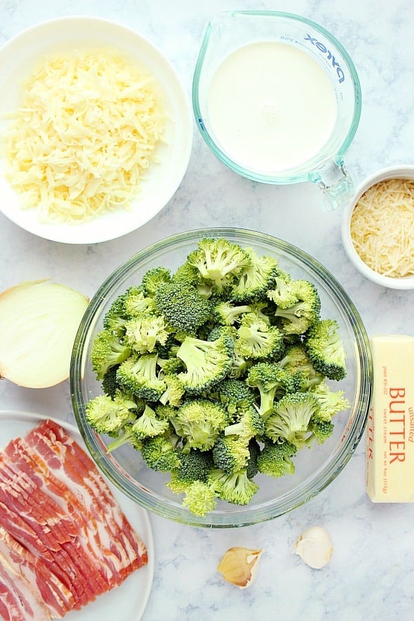 Ingredients for Creamy Broccoli dish on marble board.