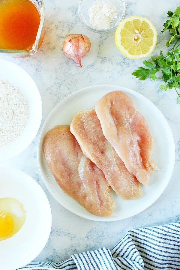 Chicken Francese ingredients on marble board.