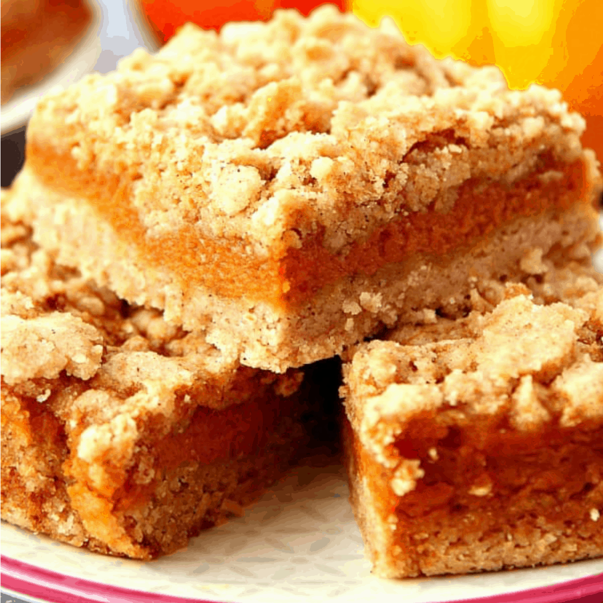Pumpkin pie bars stacked on plate.