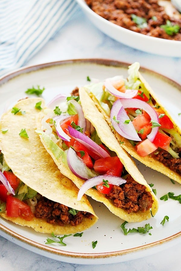 Instant Pot Taco Meat in crispy tortilla shells on a plate.
