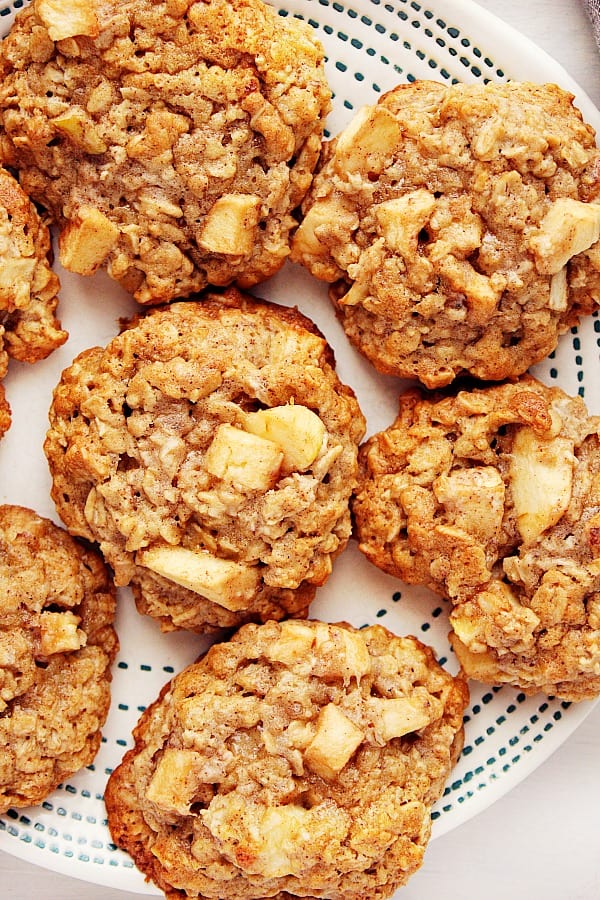 These Apple Oatmeal Cookies are packed with chunks of sweet apples and spiced with cinnamon, cloves and ginger. Apple Oatmeal Cookies on a plate.