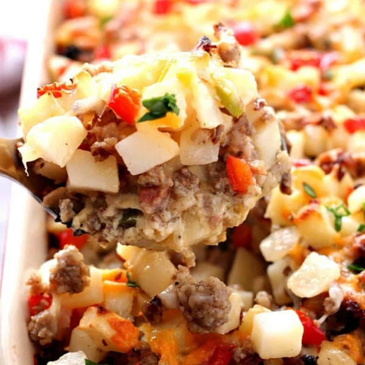 Breakfast casserole being served with a spoon.