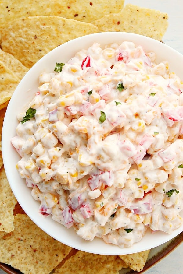 This Creamy Corn Dip is a great quick and easy appetizer idea for any party or get-together. Creamy Corn Dip in a white bowl.