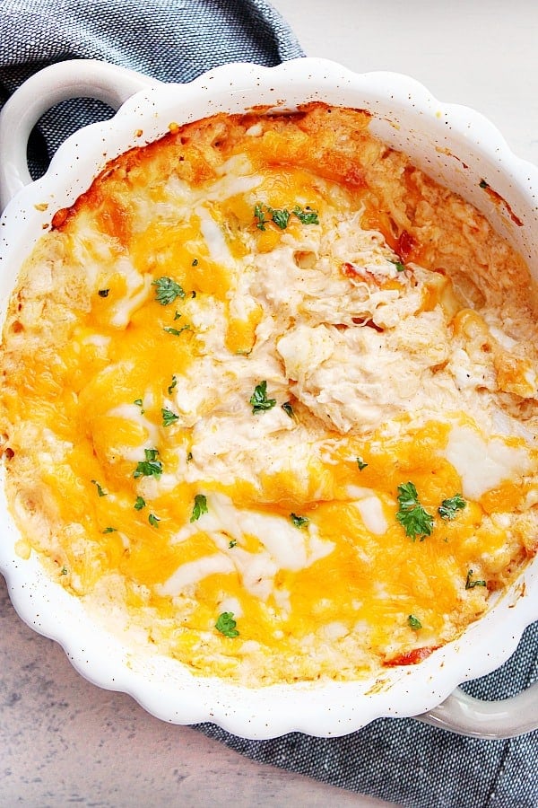 Baked Hot Crab Dip in dish, with melty cheese.
