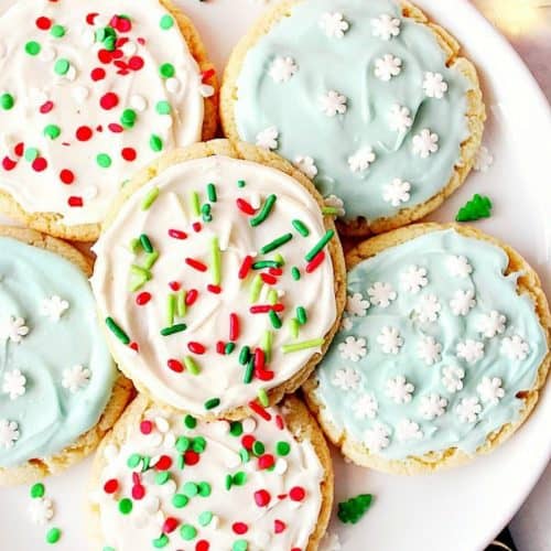 Frosted sugar cookies on a plate.