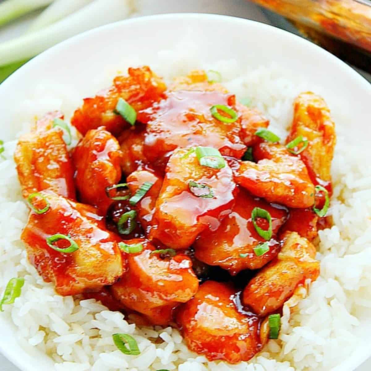 Firecracker chicken on rice in a bowl.