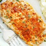 Pork chops on a white plate.