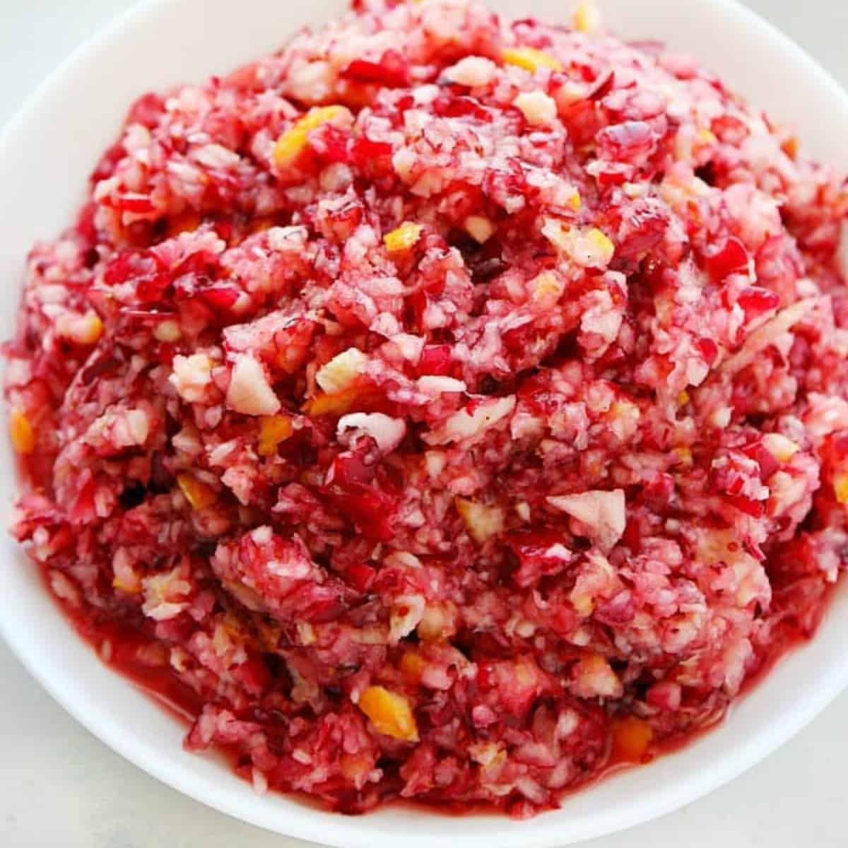 Cranberry relish in a white serving bowl.