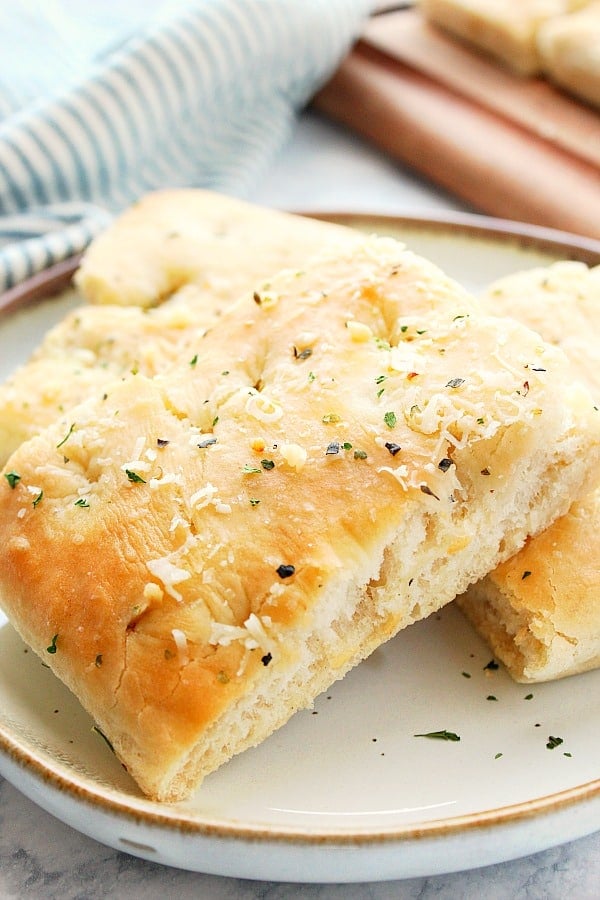 Easy Focaccia Bread - the best and easiest recipe for homemade focaccia with garlic and Parmesan cheese. Focaccia Bread slices on a white plate.
