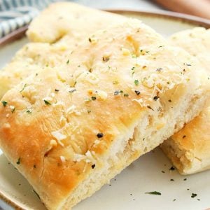 Focaccia bread sliced and on plate.