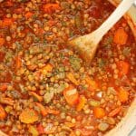 Lentil Soup in a soup pot with wooden spoon.