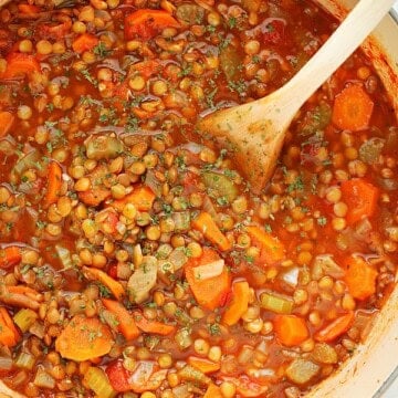 Lentil Soup in a soup pot with wooden spoon.
