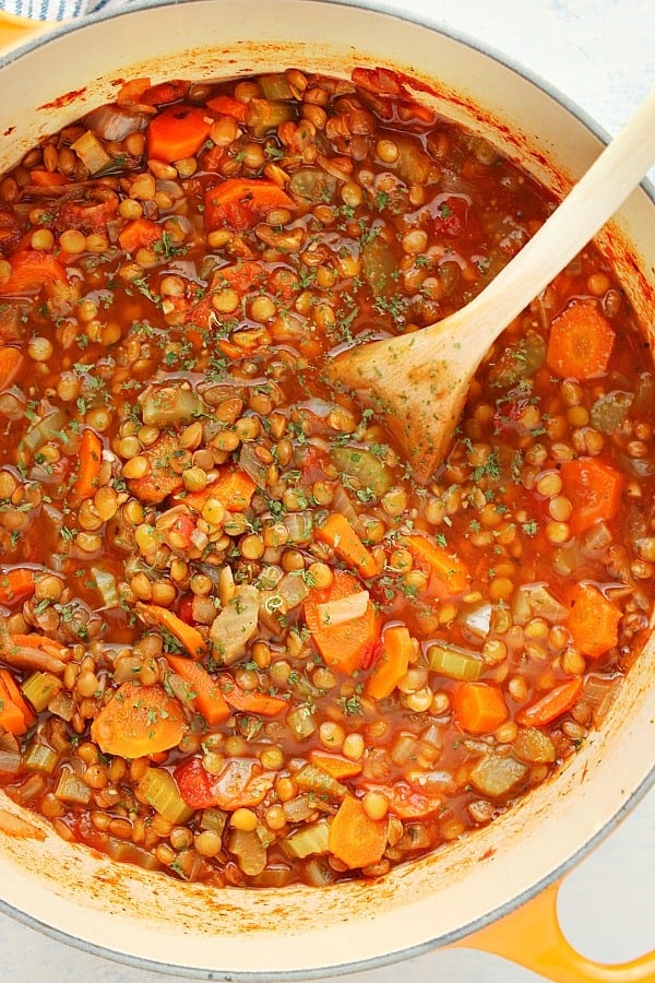 Lentil Soup in a soup pot with wooden spoon.